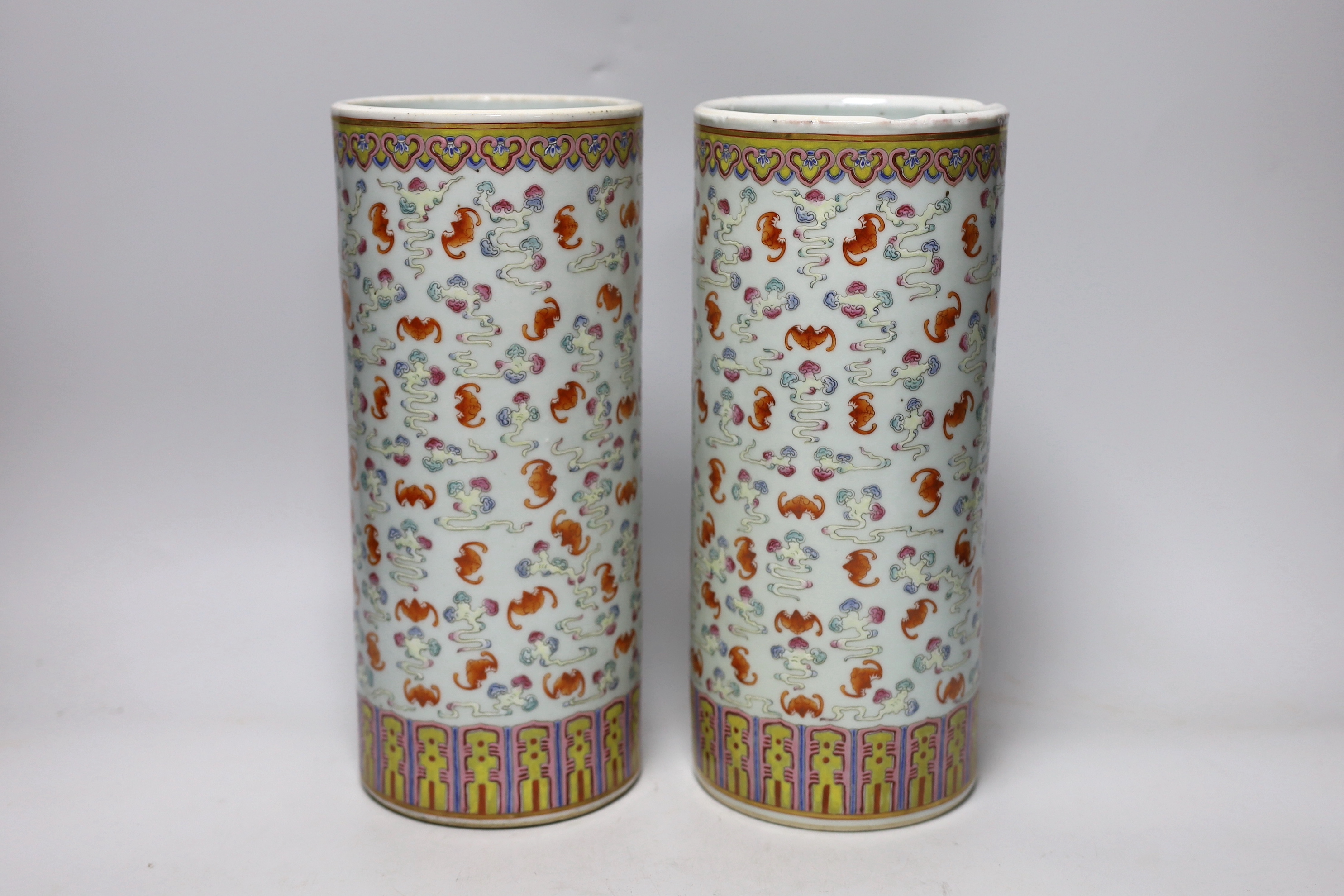 A pair of Chinese famille rose cylindrical vases, decorated with bats, each 29cm high